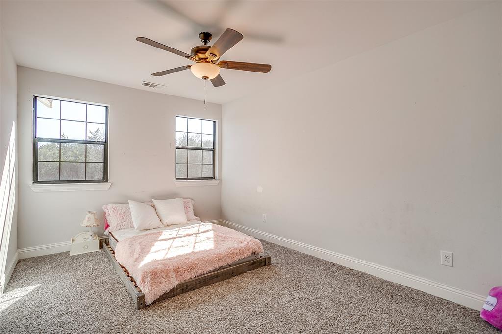4920 Shining Star Trail Rio Vista, TX 76093 - Photo 23 of 40 a bedroom with a bed and window