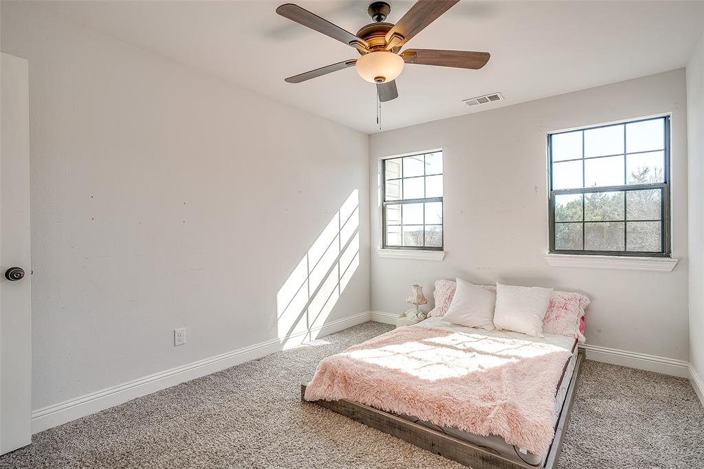 4920 Shining Star Trail Rio Vista, TX 76093 - Photo 24 of 40 a bedroom with a bed and a window