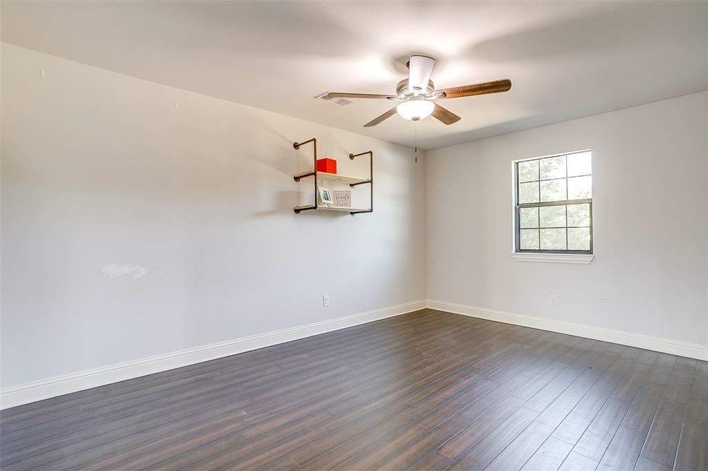 4920 Shining Star Trail Rio Vista, TX 76093 - Photo 28 of 40 wooden floor in an empty room with a window