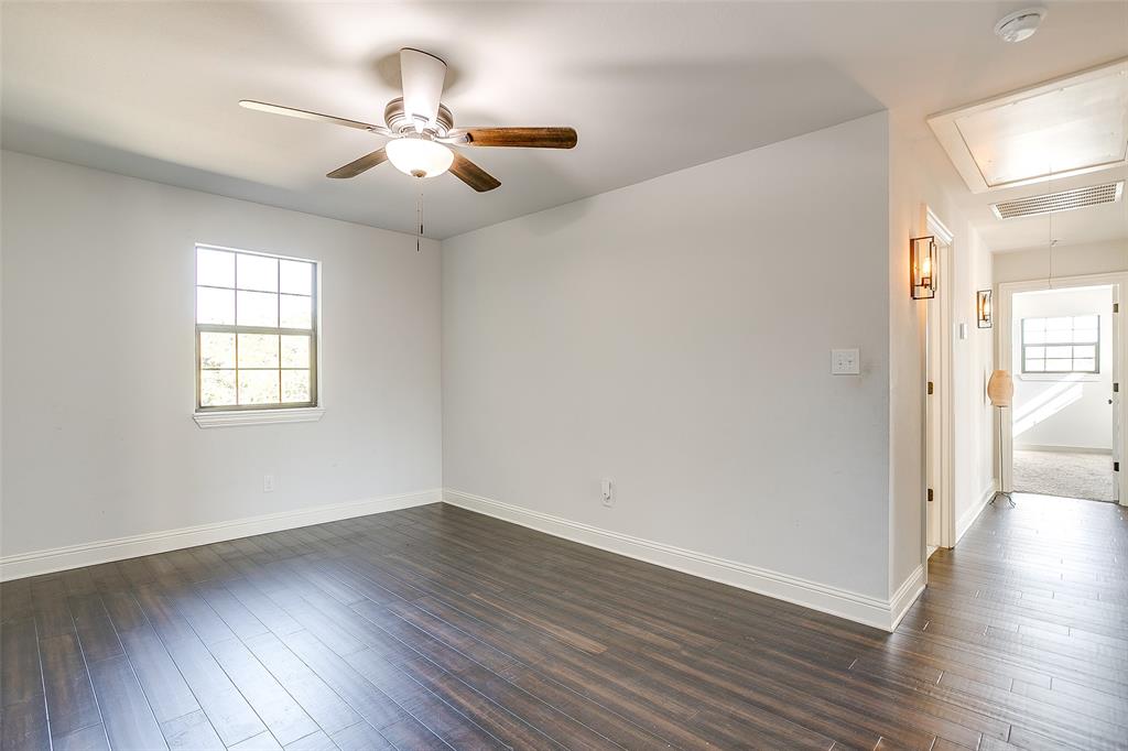 4920 Shining Star Trail Rio Vista, TX 76093 - Photo 29 of 40 an empty room with wooden floor chandelier and windows