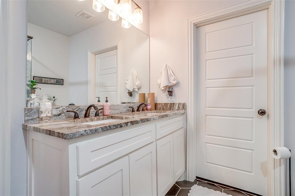 4920 Shining Star Trail Rio Vista, TX 76093 - Photo 31 of 40 a bathroom with a sink and a mirror