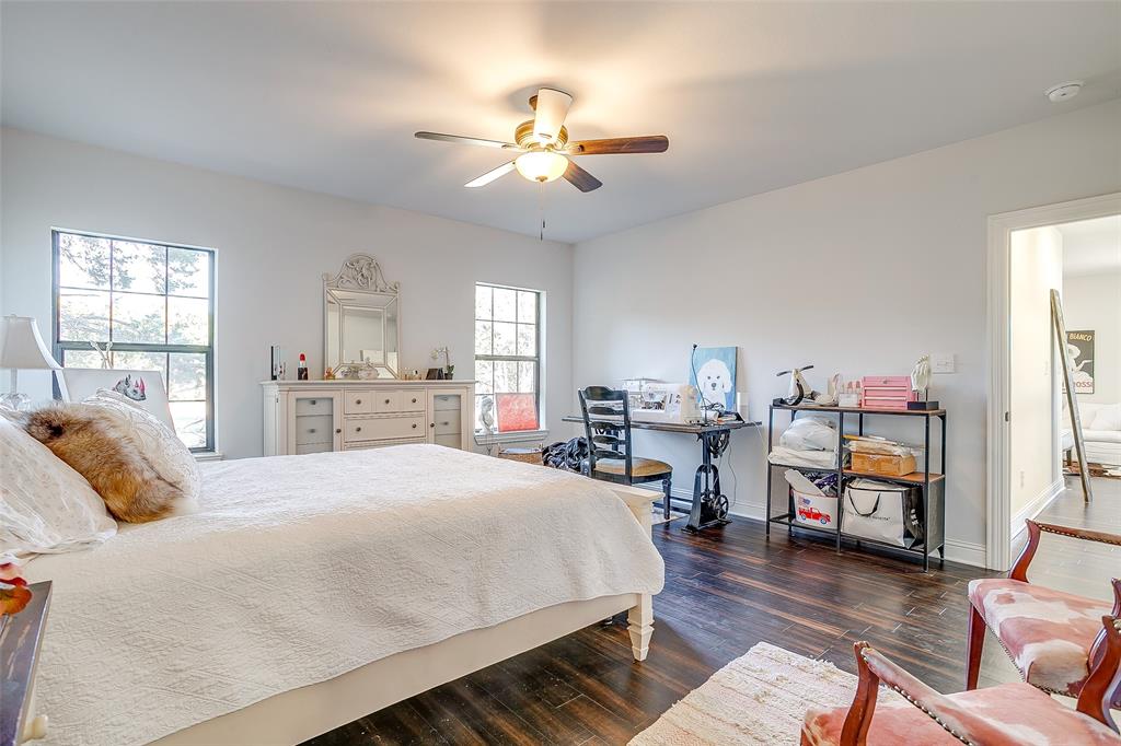 4920 Shining Star Trail Rio Vista, TX 76093 - Photo 34 of 40 a bedroom with a bed and a wooden floor