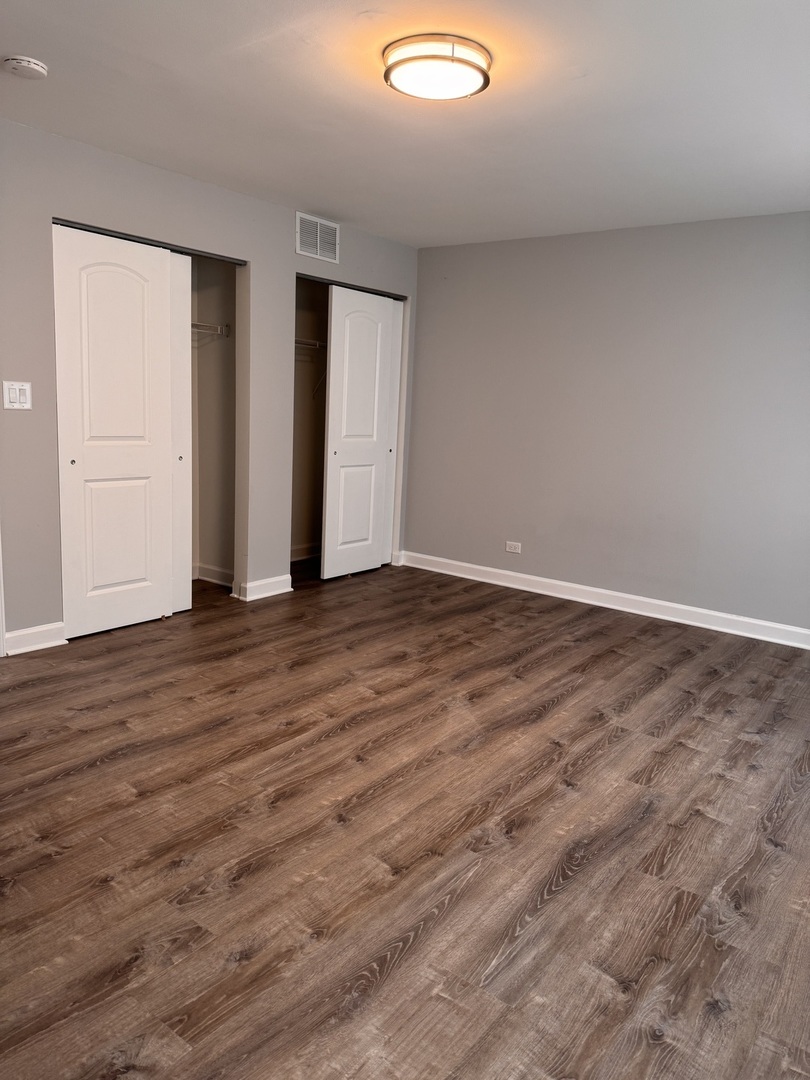 336 Lilac Lane, Unit H Elgin, IL 60123 - Photo 12 of 16 wooden floor in an empty room