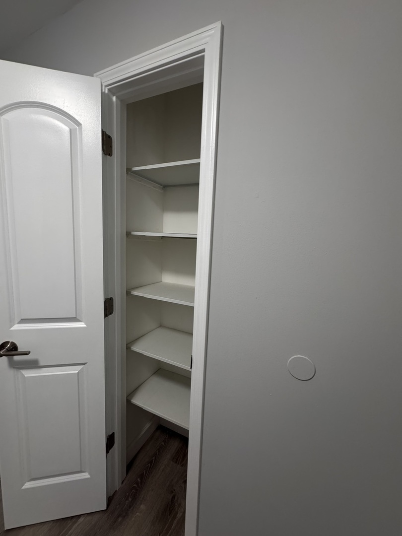 336 Lilac Lane, Unit H Elgin, IL 60123 - Photo 5 of 16 a view of a room with rack on the wall