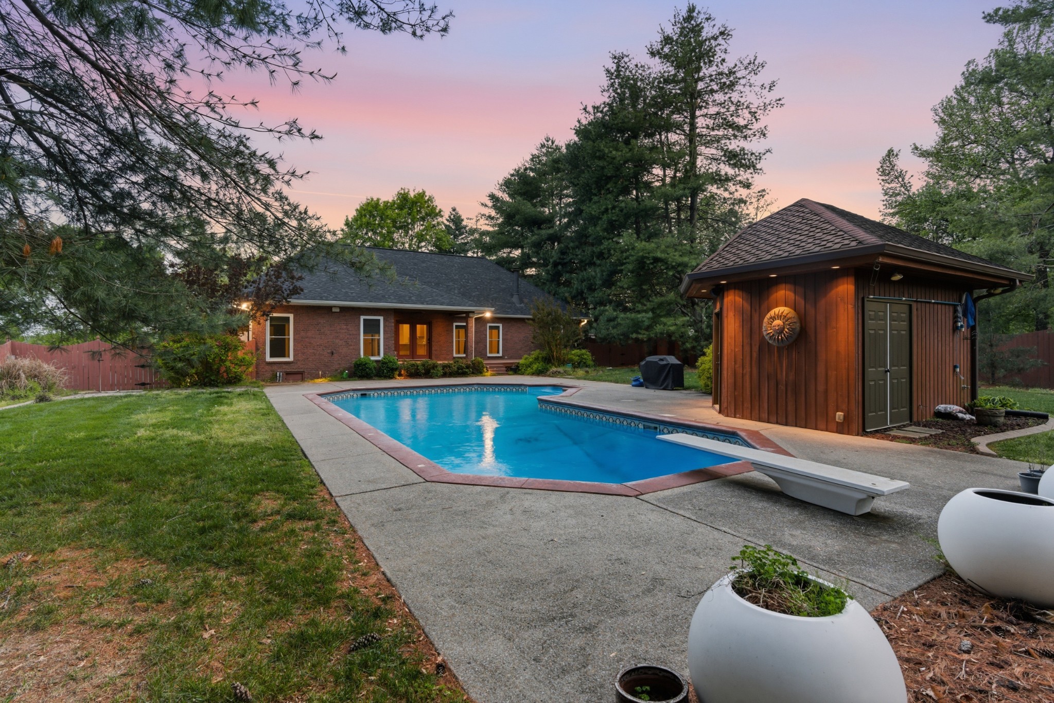 a view of house with swimming pool outdoor seating area