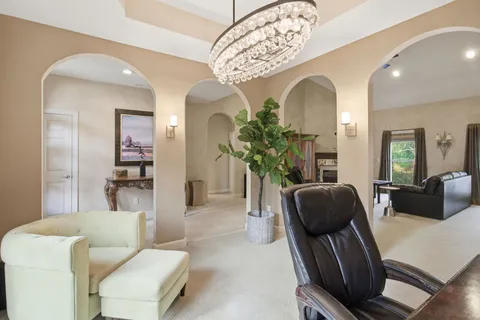 a living room with furniture fireplace and a window