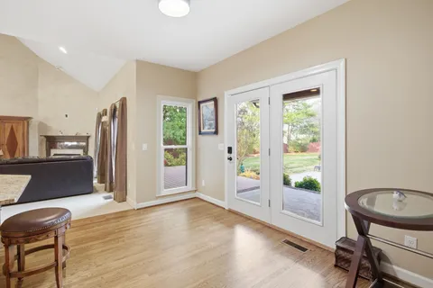 an empty room with windows and ceiling fan