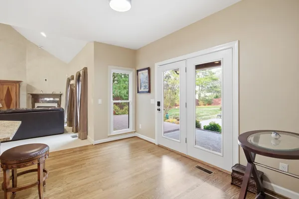 an empty room with windows and ceiling fan