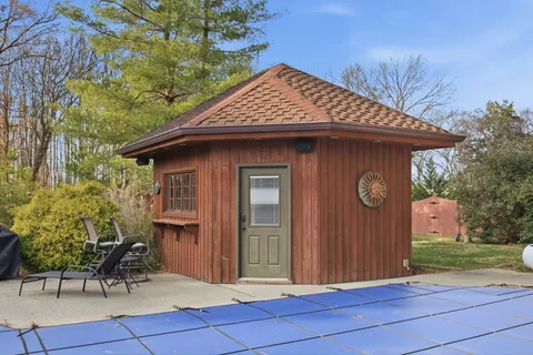 an empty room with windows and ceiling fan