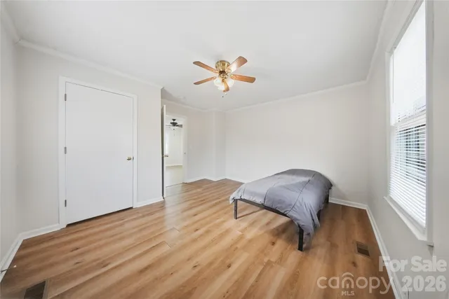 a view of workspace room with wooden floor and a window