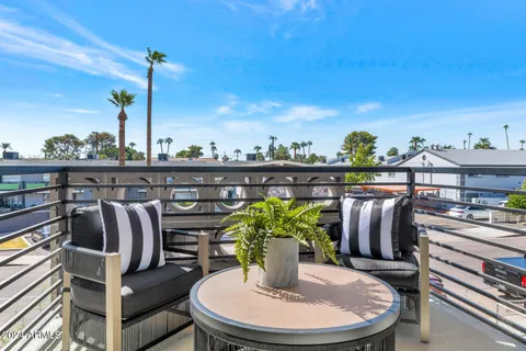 a bedroom with a bed and a mirror on the dresser