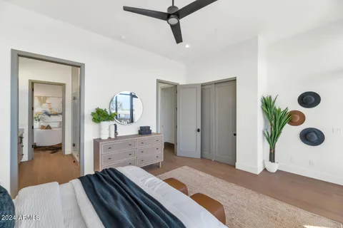 a bedroom with a bed and ceiling fan