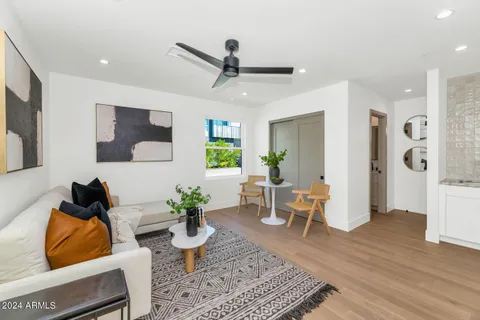 a living room with furniture and kitchen view