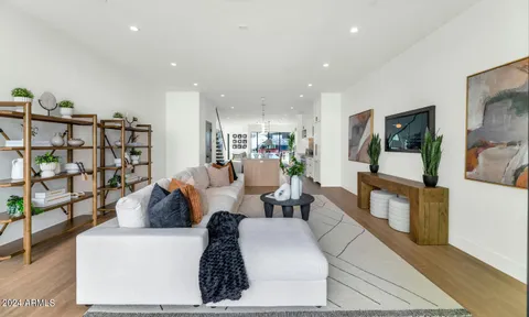 a living room with furniture and a floor to ceiling window