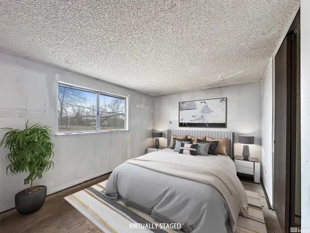 a bedroom with a bed and a potted plant