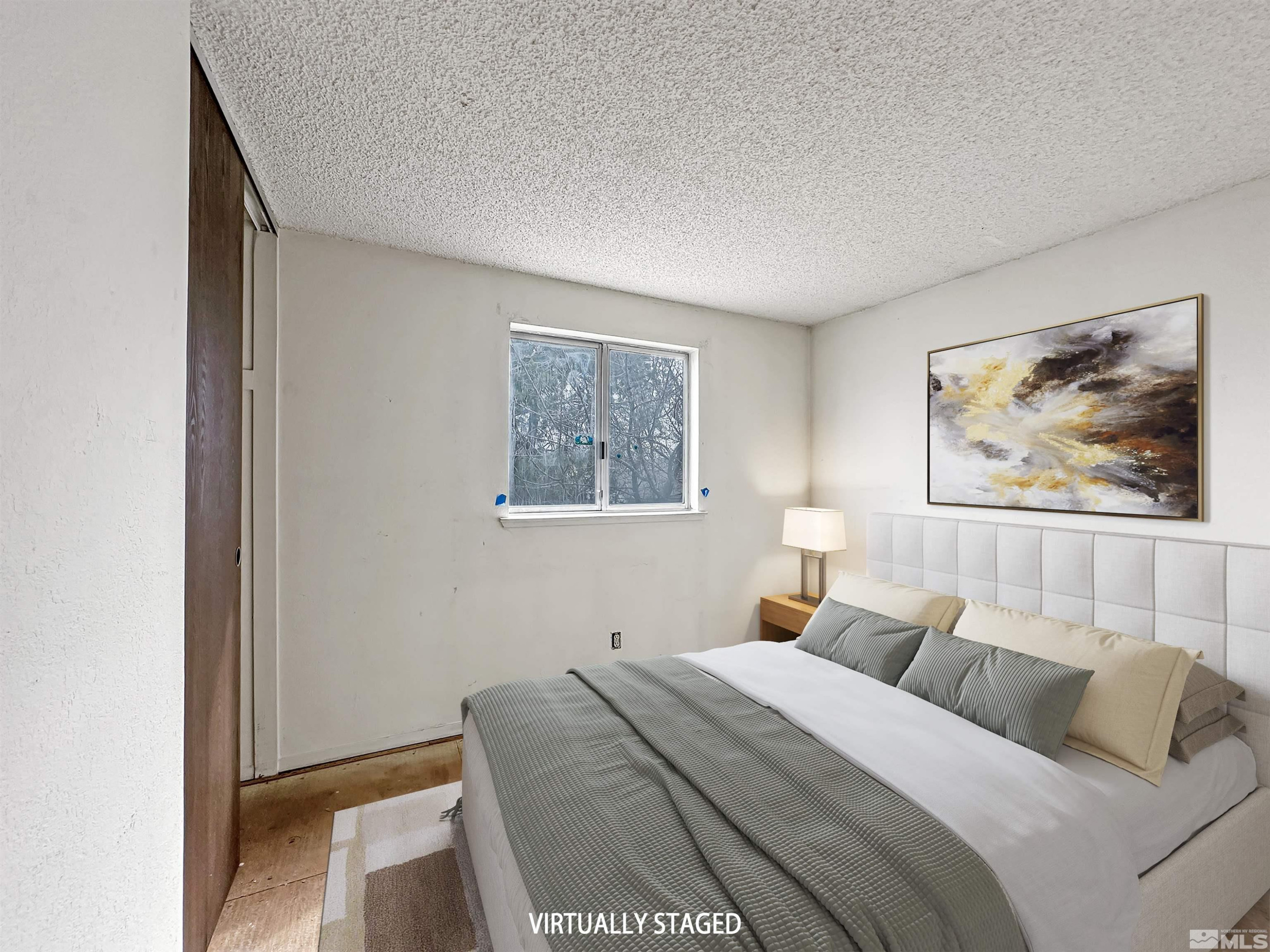 11019 Bornite Court Reno, NV 89506 - Photo 12 of 30 a bedroom with a bed and painting on the wall