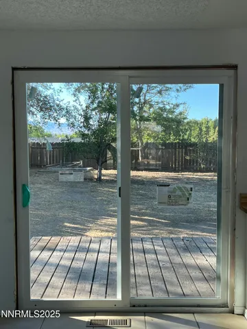 a view of empty room with wooden floor and fireplace