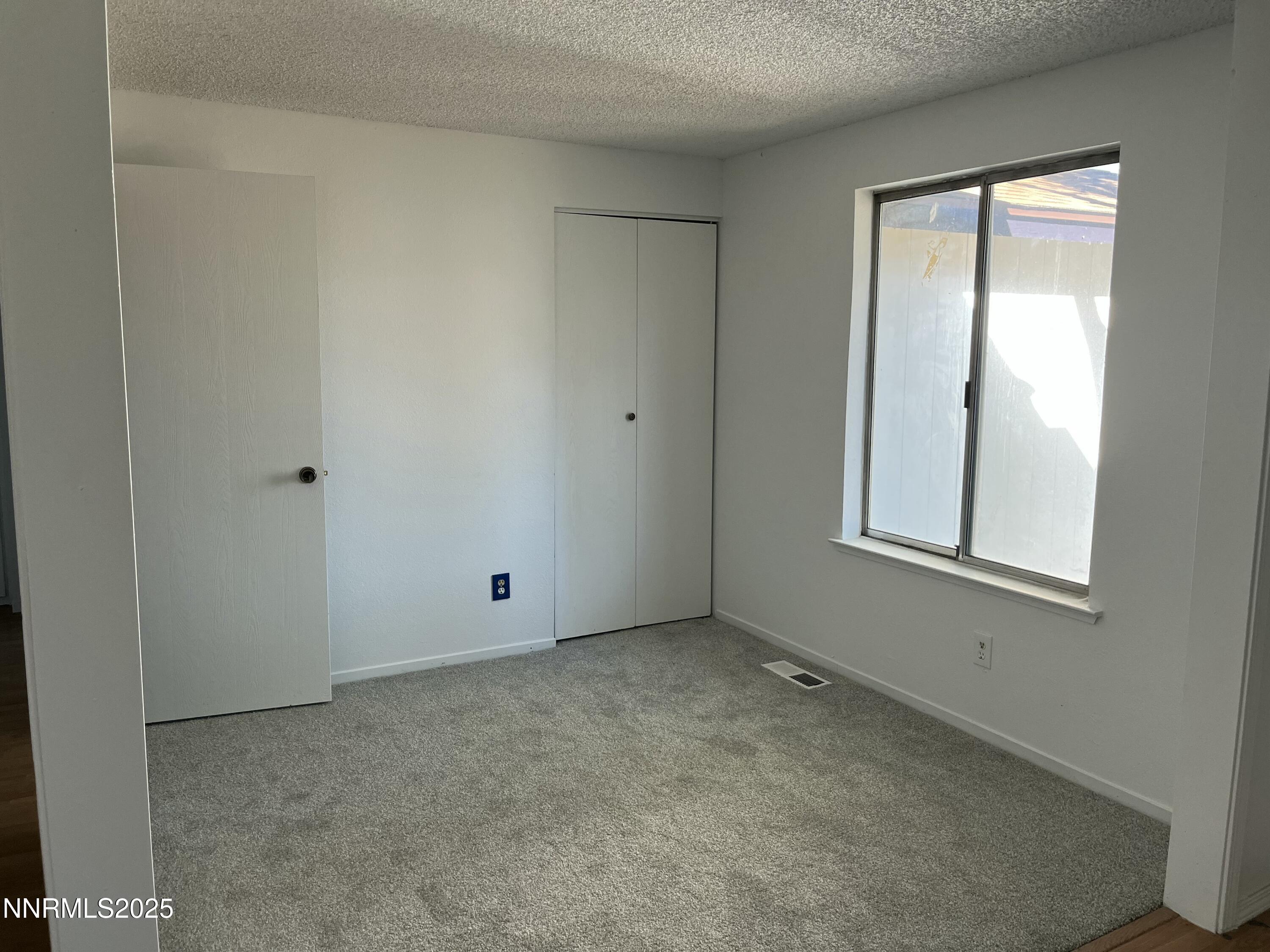 11019 Bornite Court Reno, NV 89506 - Photo 18 of 30 a view of an empty room with a window