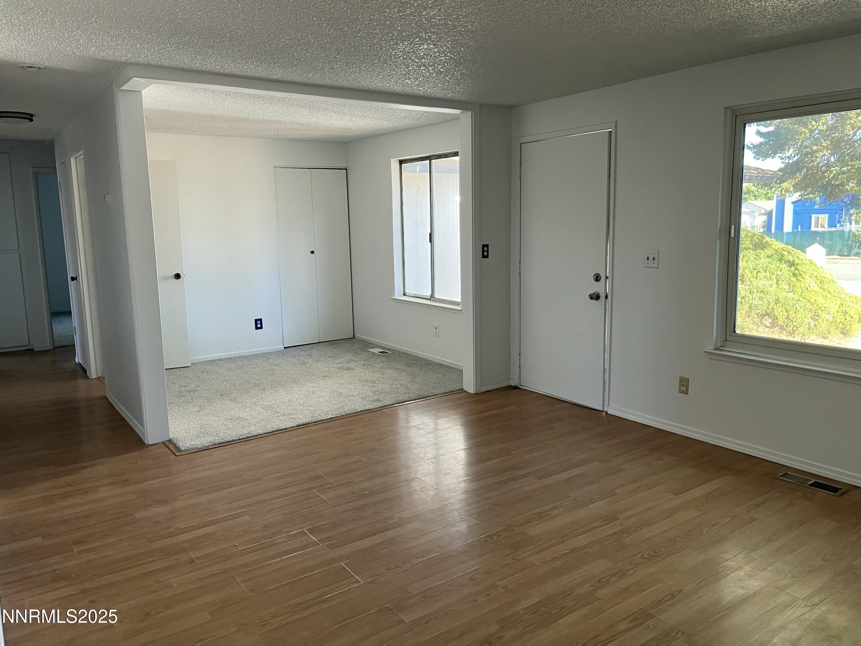 11019 Bornite Court Reno, NV 89506 - Photo 19 of 30 an empty room with wooden floor and windows