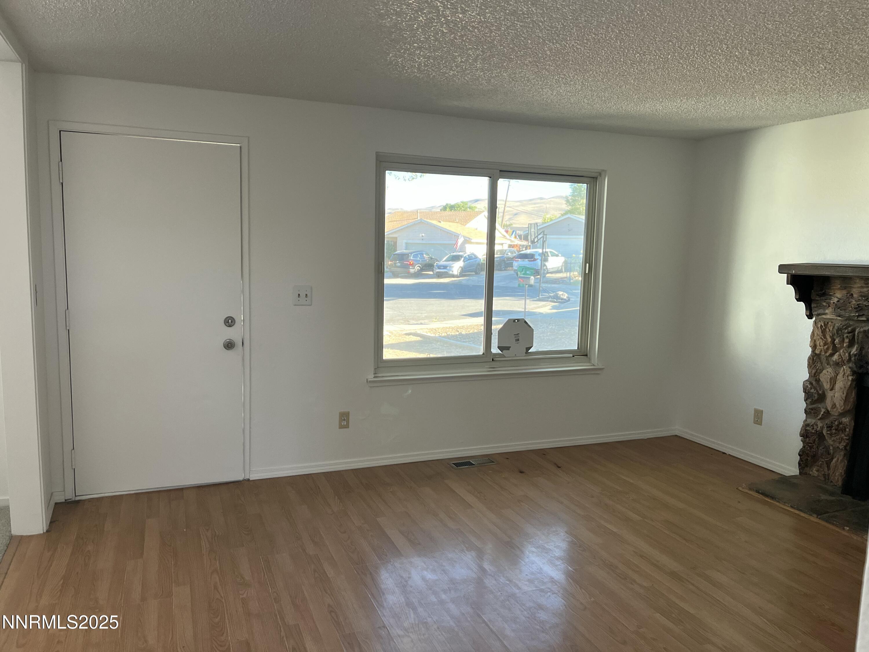 11019 Bornite Court Reno, NV 89506 - Photo 24 of 30 an empty room with wooden floor and windows
