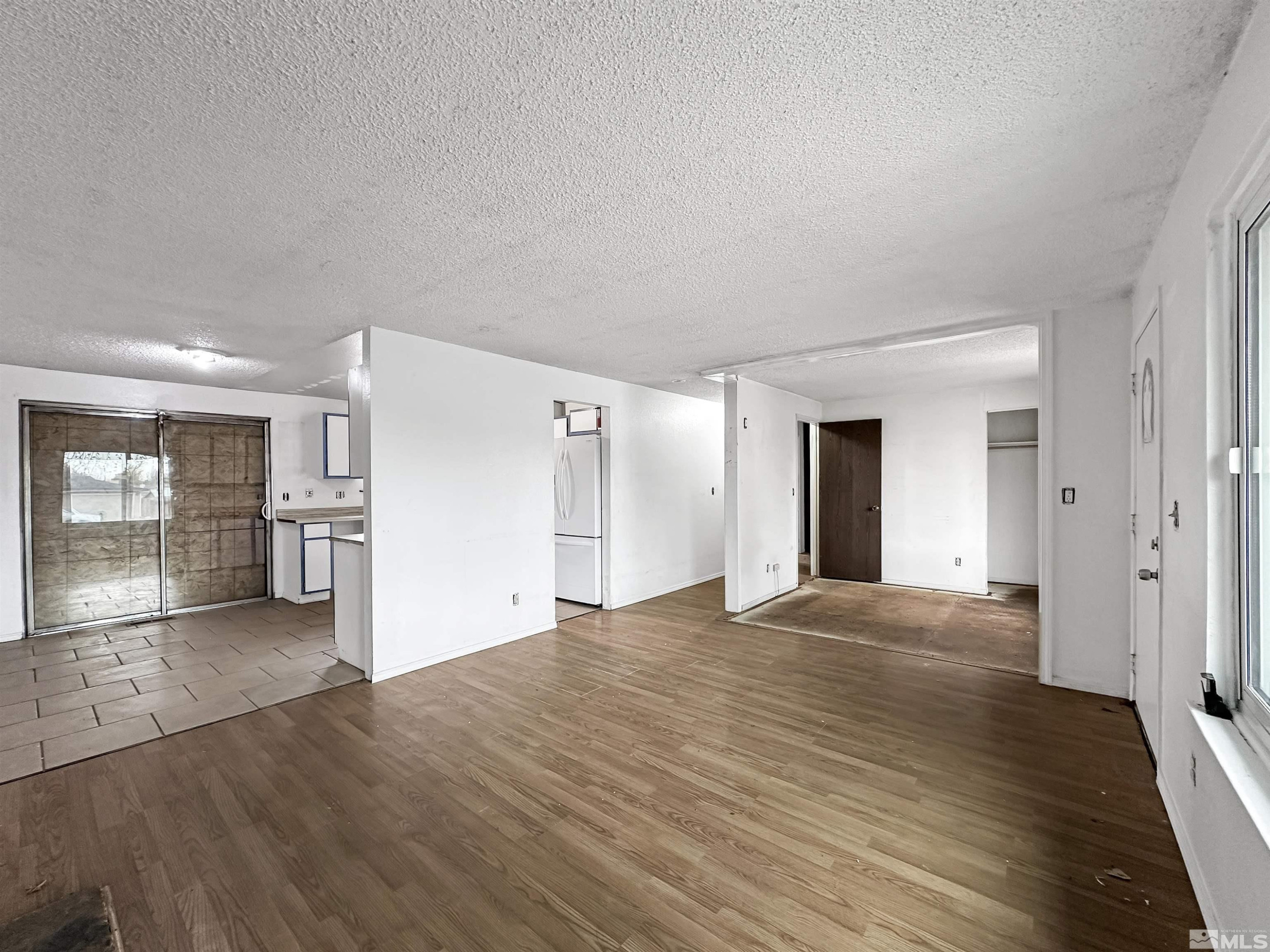 11019 Bornite Court Reno, NV 89506 - Photo 3 of 30 a view of a big room with wooden floor and a kitchen