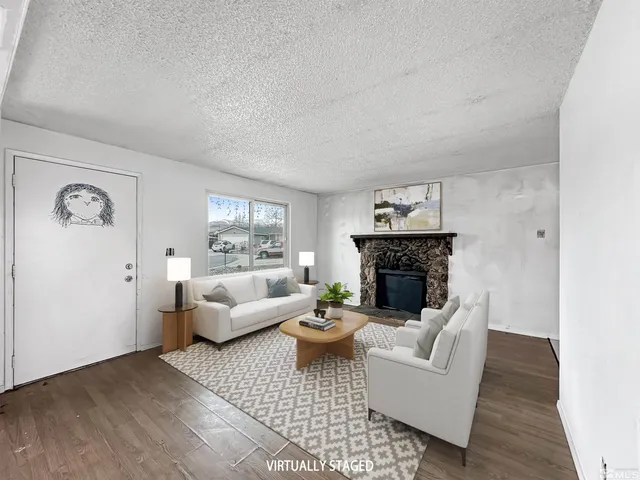 a living room with furniture a fireplace and a table