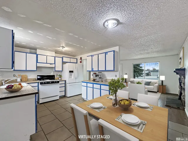 a kitchen with a sink stove and chairs