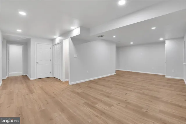 an empty room with windows and closet
