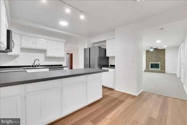 a kitchen with stainless steel appliances granite countertop a sink and cabinets