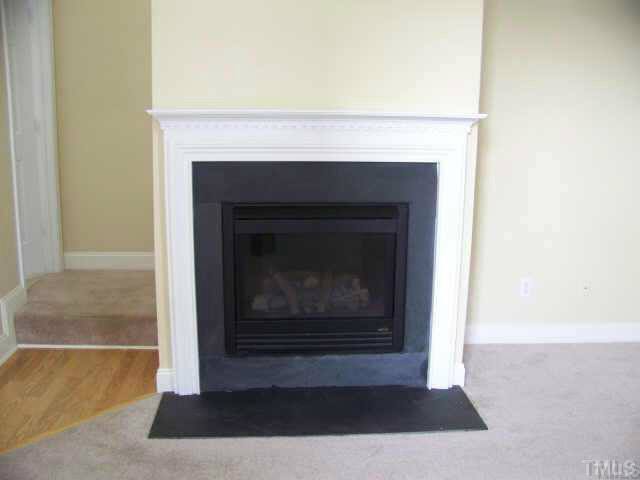 3741 Tryon Ridge Drive Raleigh, NC 27610 - Photo 3 of 6 Living room features a gas log fireplace, great for those chilly winter nights.