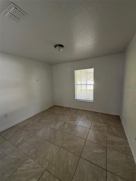 417 Francisco Way Kissimmee, FL 34758 - Photo 11 of 20 a view of an empty room and window