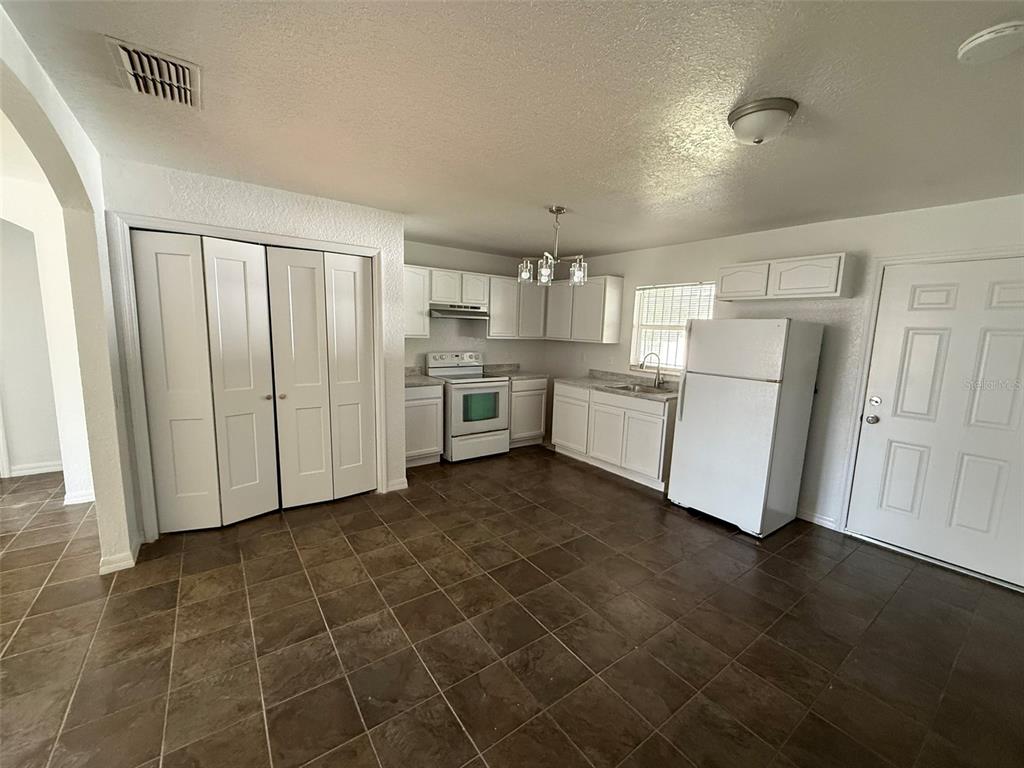 417 Francisco Way Kissimmee, FL 34758 - Photo 15 of 20 a kitchen with cabinets and wooden floor
