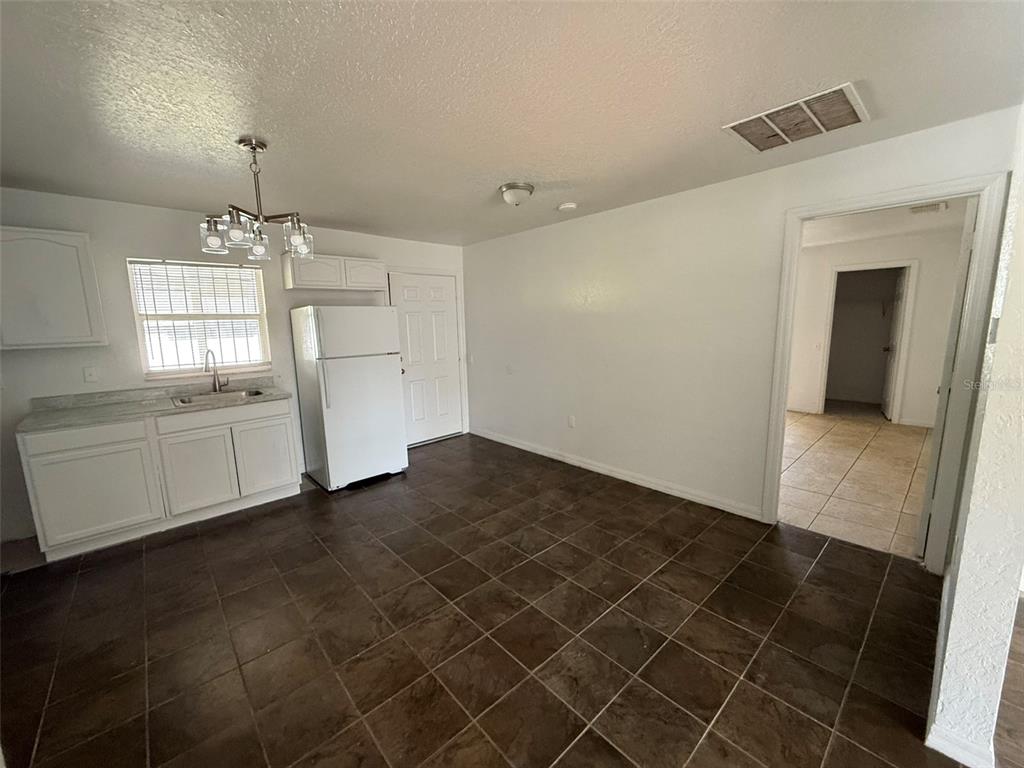 417 Francisco Way Kissimmee, FL 34758 - Photo 16 of 20 a kitchen with a sink and a refrigerator
