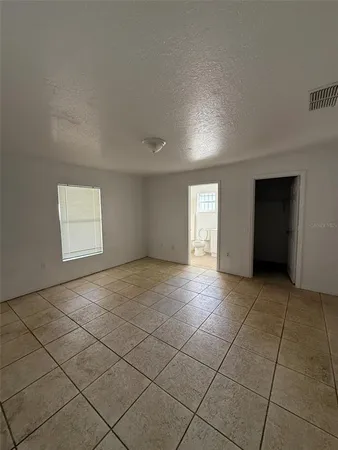 a view of an empty room and a window