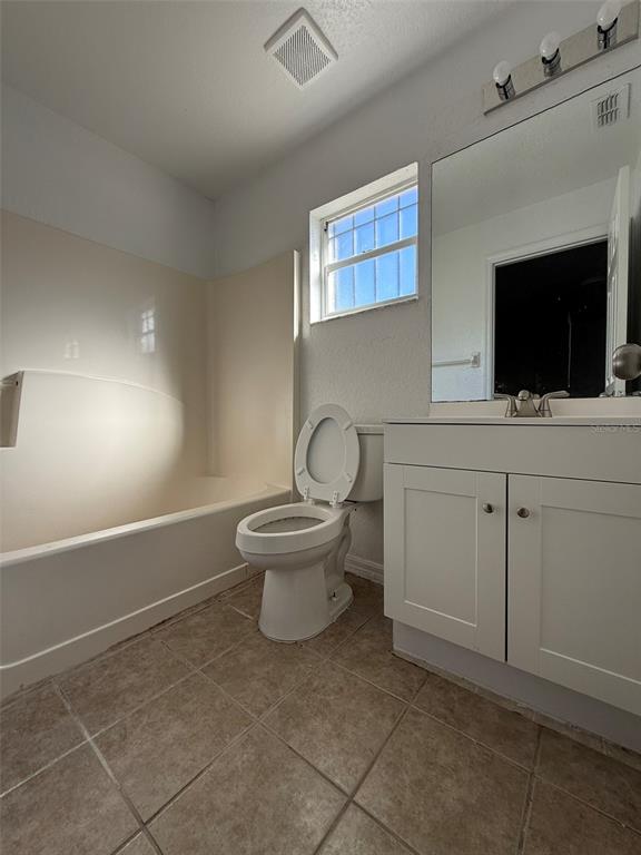 417 Francisco Way Kissimmee, FL 34758 - Photo 18 of 20 a bathroom with a toilet a sink and mirror