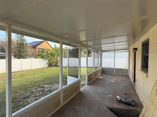a view of a porch with furniture and yard