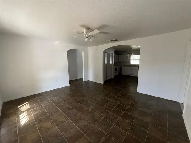 a view of a livingroom with a ceiling fan and window