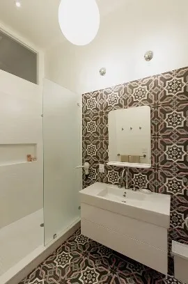 a bedroom with a bed and glass door