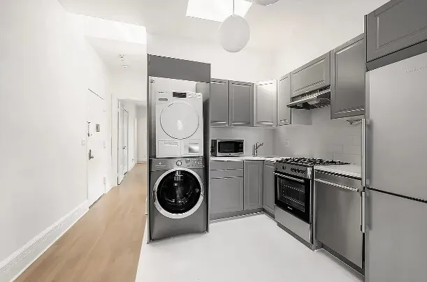 a bedroom with a bed a lamp and a potted plant