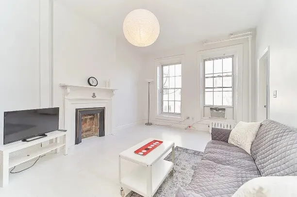a living room with furniture and a flat screen tv