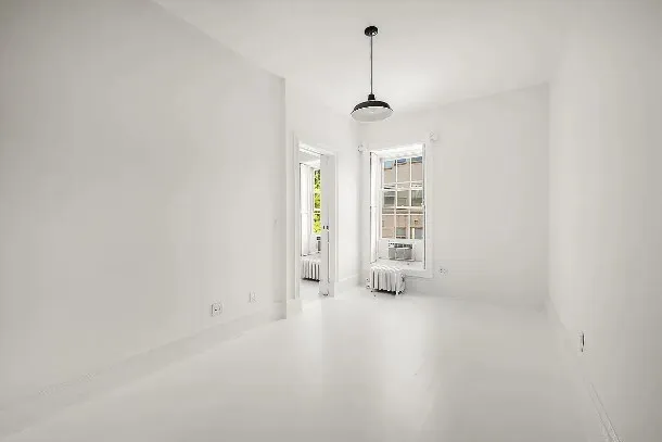 a kitchen with stainless steel appliances a refrigerator a stove and white cabinets