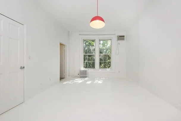a living room with furniture a fireplace and kitchen view