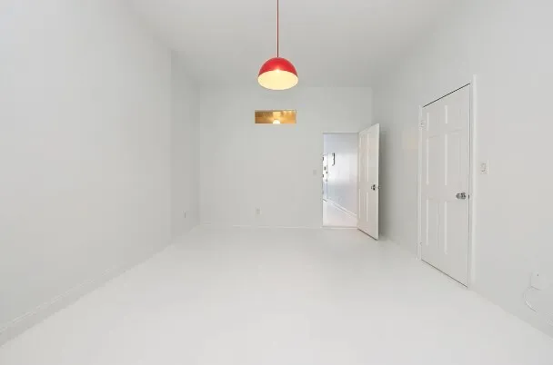 a kitchen with granite countertop a sink cabinets stainless steel appliances and a chandelier