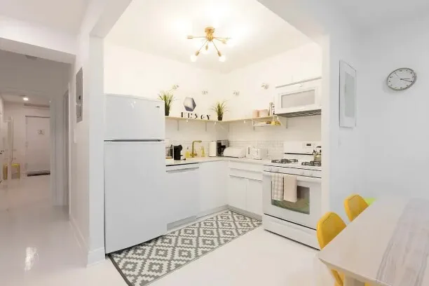 a spacious bedroom with a bed and a chandelier