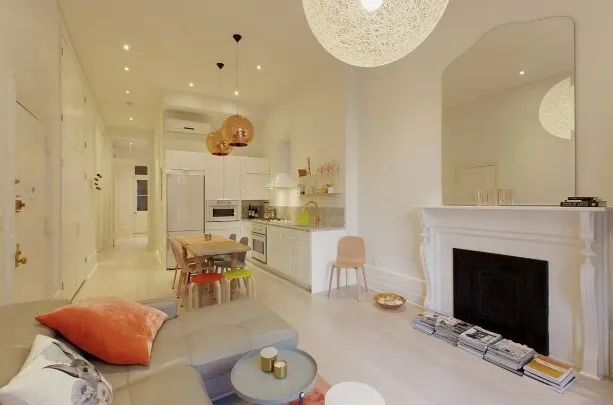 a living room with furniture a fireplace and a chandelier