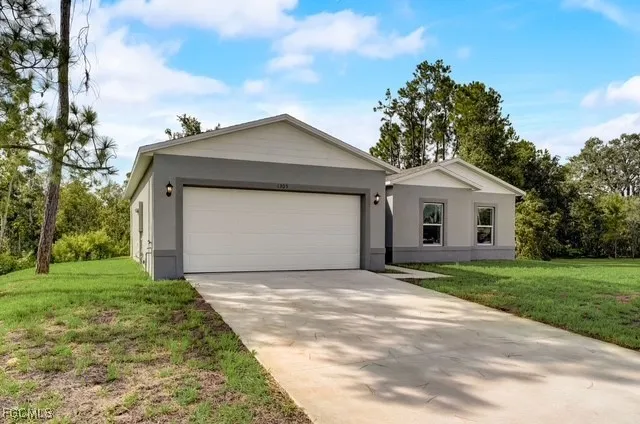 a front view of a house with a yard and garage