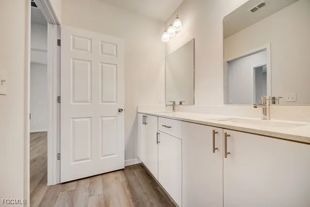 a bathroom with 2 sink and a mirror