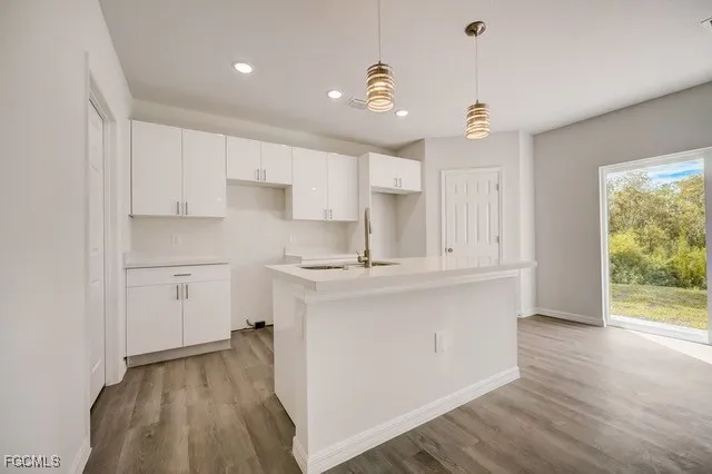 a kitchen with kitchen island a sink stainless steel appliances and cabinets