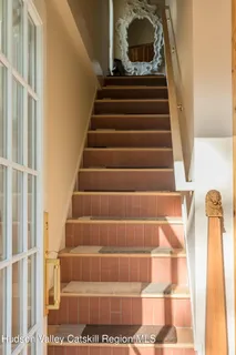 a view of a room with a window and furniture