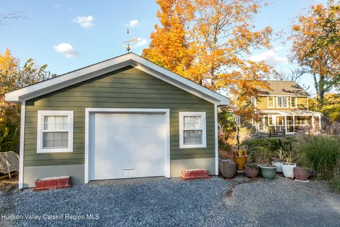 a front view of a house with a yard and potted plants